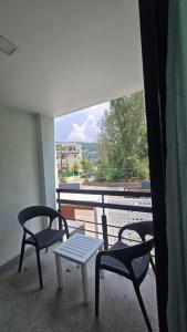two chairs and a table on a balcony with a view at joyful theKris 205 in Ban Lum Fuang