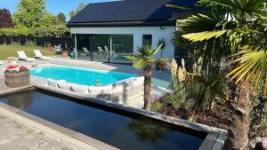 a swimming pool in the backyard of a house at Deluxe home garden and pool optional pm in Kortenberg