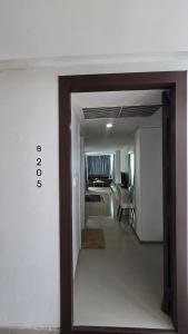 a hallway leading into a room with a living room at joyful theKris 205 in Ban Lum Fuang +2 photos