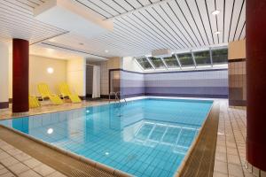 a large swimming pool in a hotel room at Wohnung C1 - Haus A Cappella in Binz
