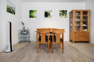 a dining room with a table and chairs and a cabinet at Wohnung C1 - Haus A Cappella in Binz