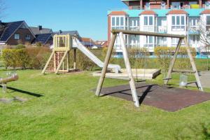 a park with a playground with a slide at Wellness Ferienwohnung Strandperle in Cuxhaven