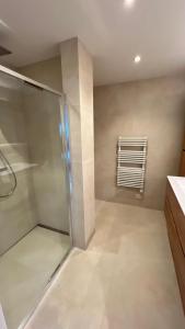 a bathroom with a walk in shower and a window at Deluxe home garden and pool optional pm in Kortenberg +28 photos
