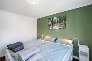 a bedroom with a large bed with towels on it at Zum alten Wald in Zell am Harmersbach