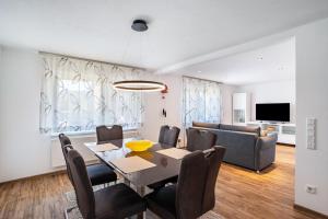 a dining room and living room with a table and chairs at Zum alten Wald in Zell am Harmersbach