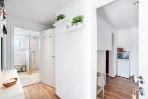 a white apartment with white walls and wood floors at Zum alten Wald in Zell am Harmersbach +25 photos