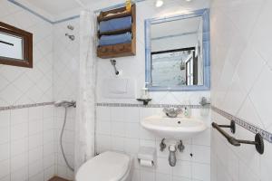 a white bathroom with a toilet and a sink at Casa Rural Madre Nieves in Fasnia +18 photos