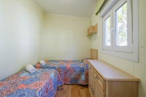 a bedroom with two beds and a window at Bungalow C in Pontevedra +20 photos