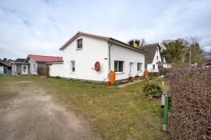 a white house with a yard in front of it at De lütt Stuf - Urlaub mit Hund in Born