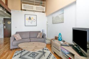 a living room with a couch and a table at Appartement face mer et Piscine in Le Croisic