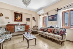a living room with two couches and a table at Barba Panais' House in Vonitsa