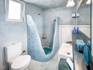 a bathroom with a sink and a toilet and a shower at Blue and White in Otziás +20 photos