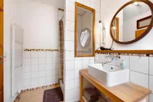 a bathroom with a sink and a mirror at Ferienwohnung Kaffee-Mühle in Sponheim +17 photos