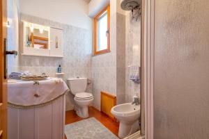 a bathroom with a toilet and a sink at Casa Sara Lu Bagnu in Castelsardo +8 photos