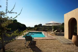 a swimming pool in a yard next to a house at Gennadi Blue Sky Villas in Gennadi