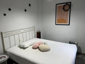 a bedroom with a bed with two pillows on it at Rodalia in El Verger +11 photos