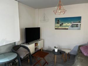 a living room with a tv and a table and chairs at Rodalia in El Verger