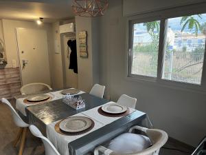 a dining room with a table and chairs and a window at Rodalia in El Verger