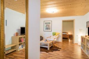 a living room with a chair and a desk at Tobelbach in Weiler-Simmerberg
