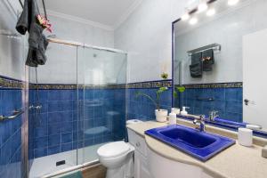 a bathroom with a toilet and a sink and a shower at Casa Alisios in Costa Calma +22 photos