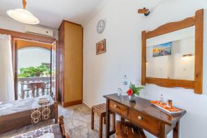 a bedroom with a desk and a mirror at Mires House Side Ground Floor 4 in Agios Gordios