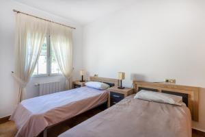 two beds in a room with a window at 5 bedroom Villa private pool in Orihuela Costa +26 photos