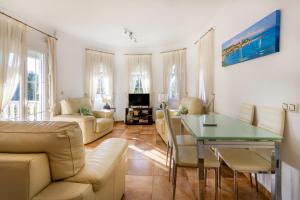 a living room with a couch and a table at 5 bedroom Villa private pool in Orihuela Costa