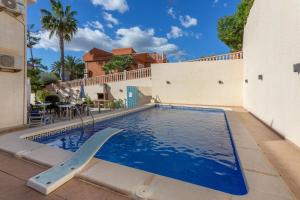 a swimming pool with a slide in front of a building at 5 bedroom Villa private pool in Orihuela Costa