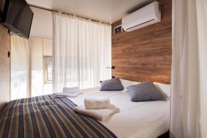 a bedroom with a large bed with a television on it at Safarizelt in Großenbrode