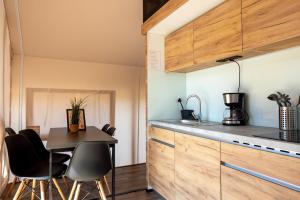 a kitchen and dining room with a table and chairs at Safarizelt in Großenbrode +5 photos