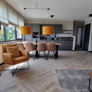 a kitchen and dining room with a table and chairs at Wellnessappartement Winterberg D4 in Winterberg