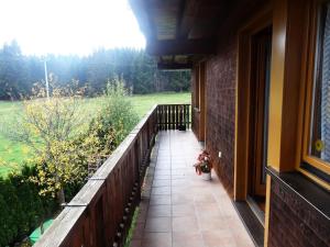 a porch of a house with a view of a field at Ferienwohnung Wernet in Schönwald