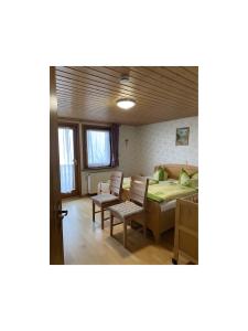 a room with a bed and a table and chairs at Ferienwohnung Wernet in Schönwald