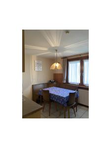 a dining room with a table and a couch at Ferienwohnung Wernet in Schönwald
