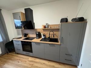 a kitchen with a sink and a counter top at Ahlers am Wald in Edewecht +5 photos