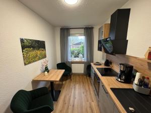 a kitchen with a table and a counter top at Ahlers am Wald in Edewecht