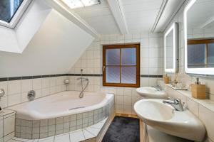 a bathroom with two sinks and a large tub at Schwarzwaldmomente in Hornberg +22 photos