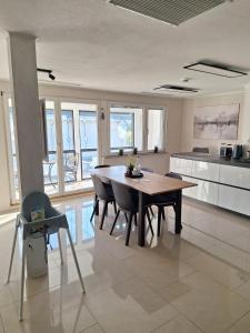 a kitchen with a dining room table and chairs at Pure Vista Hank Schwarzwaldblick in Luttingen