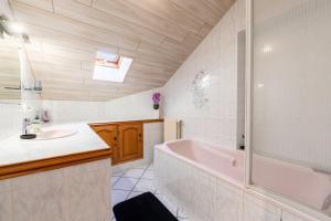 a bathroom with a pink tub and a sink at Gîte le Chamoyard in Chamoux-sur-Gelon +17 photos