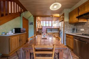 a kitchen with a large wooden table and chairs at Gîte le Chamoyard in Chamoux-sur-Gelon