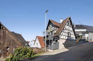 a black and white building on the side of a street at Apartmenthaus Ferienwohnungen Sila in Weinstadt