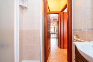 a bathroom with a shower and a sink and a mirror at Appartamento Pinus in Santa Margherita di Pula +15 photos