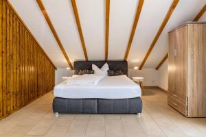 a bedroom with a large bed and wooden walls at Ferienwohnungen Martin Lafar in Öhningen