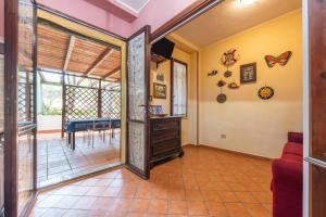 a living room with a sliding glass door and a dining room at Appartamento Pinus in Santa Margherita di Pula