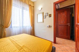 a bedroom with a bed and a window and a door at Appartamento Pinus in Santa Margherita di Pula