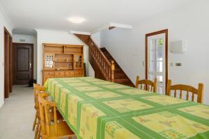 a bedroom with a table and chairs and a staircase at Casa Dona Lola in Moledo