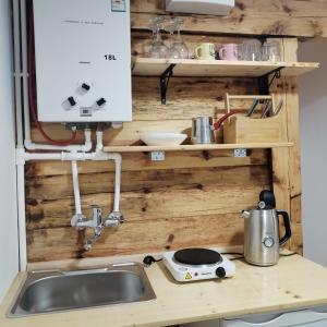 a kitchen counter with a sink and a stove at Zlatibor Koliba Laki in Zlatibor