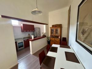 a kitchen with a table and chairs and a dining room at Harmonija26 in Karlovac