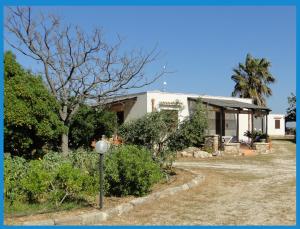 a house with a street light in front of it at Isola Di Favignana in Favignana