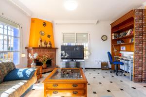 a living room with a couch and a coffee table at Milestone House in Rincón de la Victoria